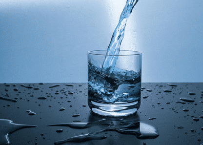 Filling a water glass on the table