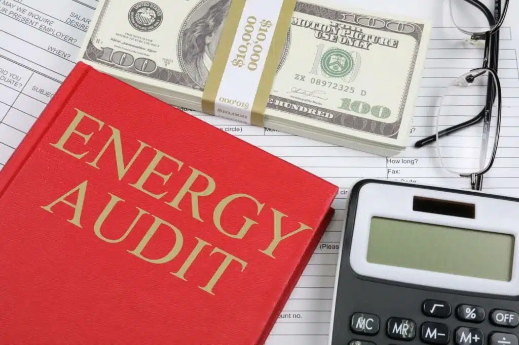 Energy Audit Red book, calculator, bills and eyeglasses