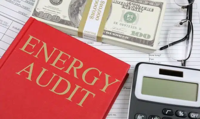 Energy Audit Red book, calculator, bills and eyeglasses