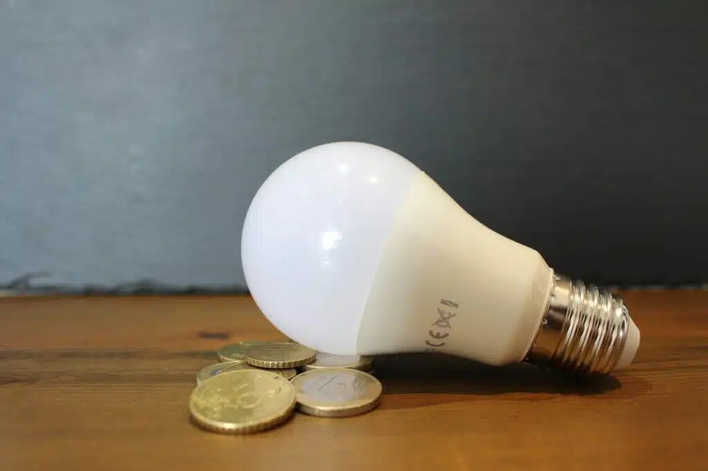 Light bulb and pennies on the table - electrical contracting 